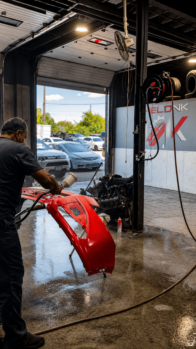 Technician at work inside the Helonk Auto shop